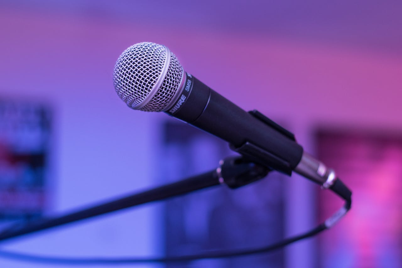 about-bg A focused capture of a microphone in a studio environment, ideal for audio-themed projects.